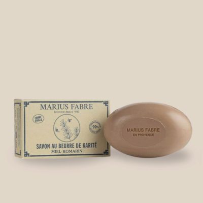 Product photo: Oval brown soap with shea butter and sweet almond oil, honey-rosemary scented, comes in a recycled box.