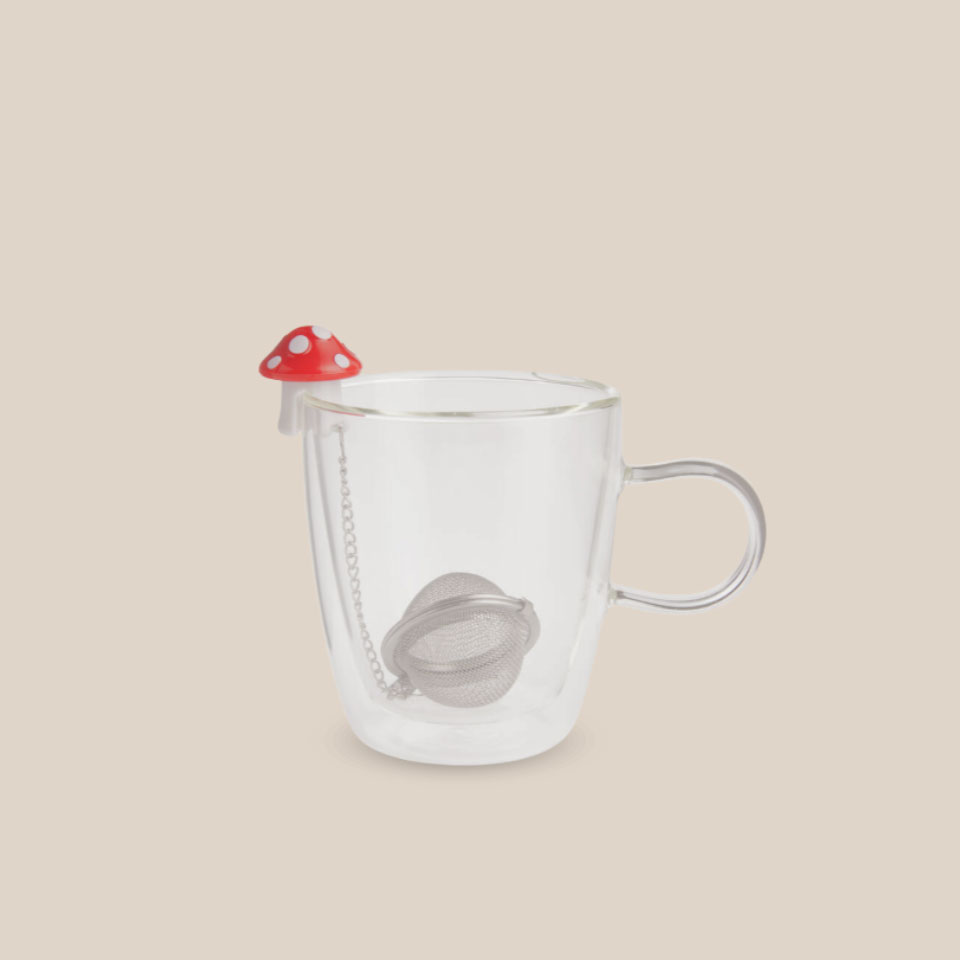 Mushroom-shaped tea infuser in a cup